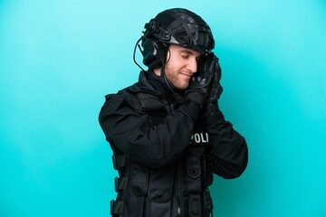 SWAT caucasian man isolated on blue background making sleep gesture in dorable expression