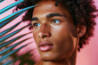 © Michael - Young man with tropical leaf on pink background