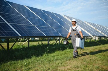 Wall Mural - Indian worker installing solar panels. Concept of alternative, renewable energy