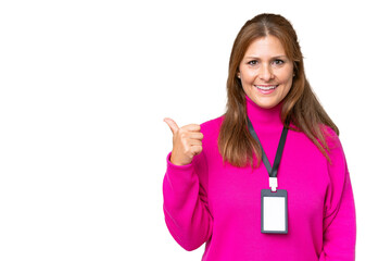 Wall Mural - Middle-aged caucasian woman with ID card over isolated background pointing to the side to present a product