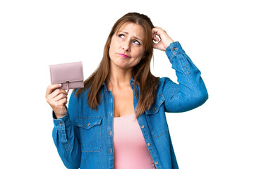 Wall Mural - Middle age caucasian woman holding wallet over isolated background having doubts and with confuse face expression