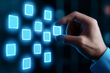 A hand interacts with a digital screen displaying glowing square icons, symbolizing technology and innovation.