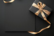© enterdigital - Elegant black gift box with gold ribbon and blank card on dark background, perfect for special occasions and celebrations.