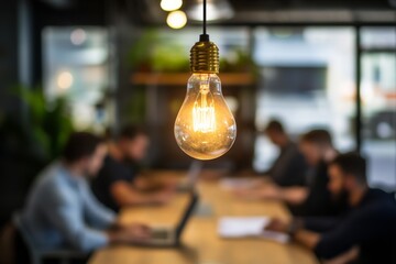 Aufkleber - A Collaborative Workspace Featuring an Illuminated Light Bulb, Perfect for Fostering Ideas, Enhancing Ambiance, and Promoting Teamwork Among Professionals in a Modern Office Environment