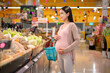 © tonefotografia - Beautiful pregnant woman shopping healthy food at grocery shop