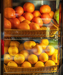 Stacked Oranges on Shelves Inside a Fruit Shop