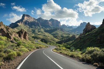 Wall Mural - A winding road through lush mountains under a bright sky, showcasing natural beauty.