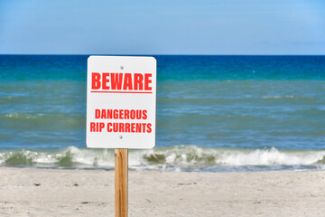 Wall Mural - Dangerous rip current signs posted on Florida beach. 