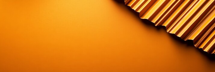 A minimalist abstract background featuring a piece of corrugated cardboard with a gold texture,  placed on a vibrant orange background. It represents the concept of autumn, Halloween, and modern desig