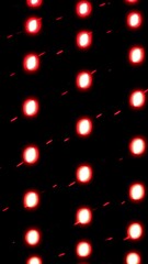 Fototapete - Vertical bending rows of small lights rotating on a dark background. Design. Spinning glowing light bulbs.
