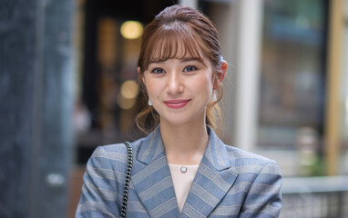 Woman blue blazer smile. Young woman wearing a blue blazer and smiling. Her confident expression radiates positivity and success.