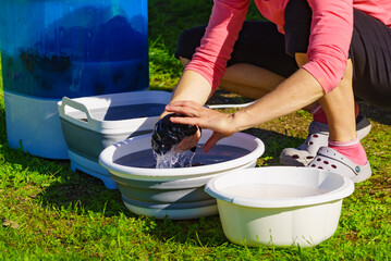 Canvas Print - Woman washing laundry outdoor