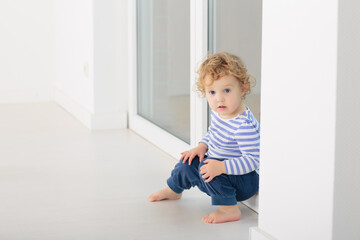 Wall Mural - Toddler child in white bedroom