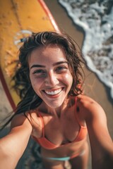 Poster - A woman is smiling and wearing a yellow surfboard. She is taking a selfie on the beach