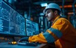 © tongpatong - A control system worker keeping an eye on an industrial pipeline power plant's operator room