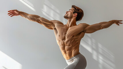 Muscular dancer man posing gracefully, emphasizing his defined physique. Natural lighting, white background. Concept of fitness, strength, health.