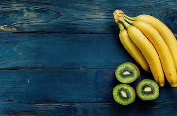 Wall Mural - Yellow Bananas and Green Kiwi on a Blue Wooden Background