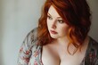 © Andrii Zastrozhnov - A woman with red hair and a large bust is looking at the camera. She has a red shirt on and is wearing a necklace