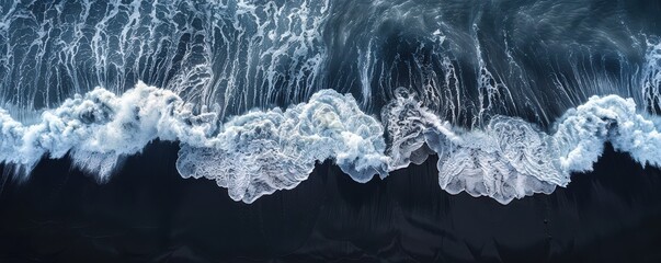 Wall Mural - Waves crashing on a black sand beach, aerial view of dynamic ocean patterns. Free copy space for text.