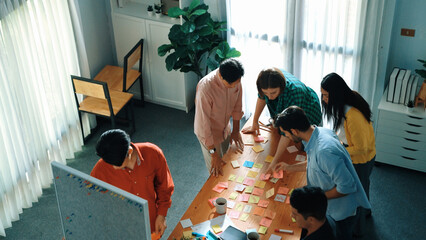 Poster - top view of diverse business people writing and stick sticky notes at whiteboard. creative team work