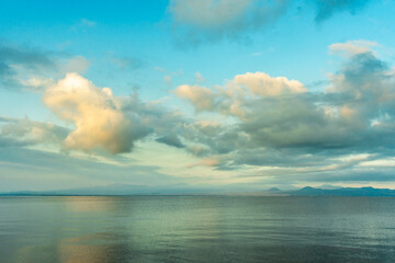 Wall Mural - beautiful sunrise with dramatic clouds over the lake and mountains.