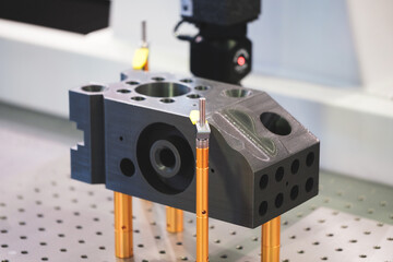 Poster - A machine is drilling a hole into a piece of metal. The machine is a CNC machine, which means it is computer controlled