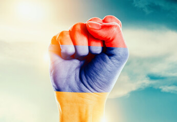 Armenia national flag fist raise in the sky. The hand with flag raise in beautiful soft sky. Armenia national flag for independence day.