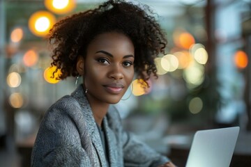 Wall Mural - african american businesswoman working from home, having a virtual group videoconference on her lapt