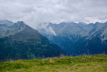 Wall Mural - view of an amazing mountain landscape on a hazy day with gray clouds and fog over the peaks in autum