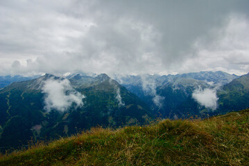 Wall Mural - view of an amazing mountain landscape on a hazy day with gray clouds and fog over the peaks in autum