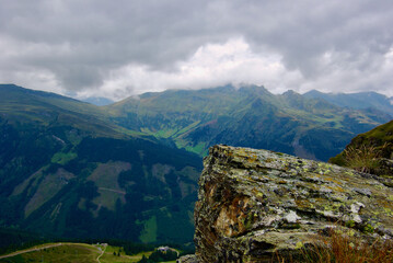Wall Mural - view of an amazing mountain landscape on a hazy day with gray clouds and fog over the peaks in autum