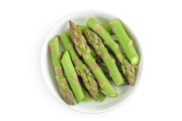 Wall Mural - fresh asparagus in ceramic bowl isolated on white background. Top view. Flat lay.