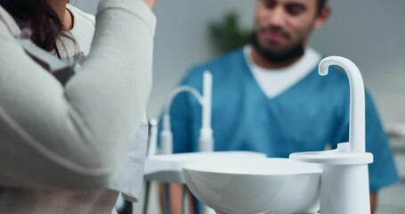 Poster - Woman, patient and dentist with rinsing mouth for preparation procedure in hospital or oral care clinic. Female person, health professional and hygiene for teeth cleaning, tooth extraction or filling