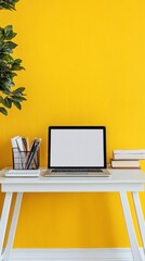 Fototapete - Creative worktable with blank screen laptop, stationery and books on white table with yellow wall