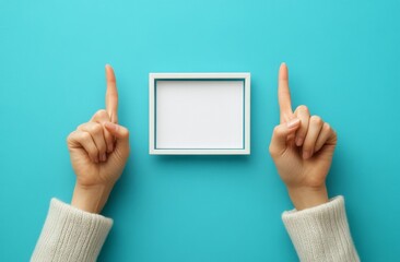 The hands of a woman are showing the gesture of cropping compositions. The image is isolated on blue background.