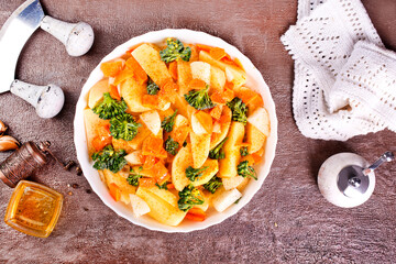 Wall Mural - Raw potatoes, garlic, onions, carrots in white bowl reading for cooking, mix vegetables