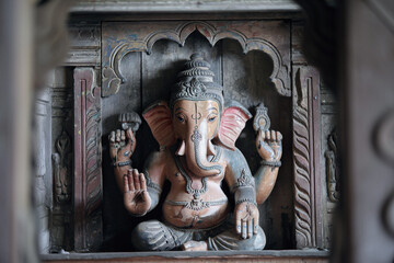 Ganesh statue in an wooden altar