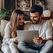 © DesignDepot - Happy wife and husband using laptop at home, make video call to family using application, watching on-line movie via digital streaming subscription services, enjoy pleasant pastime at home on internet