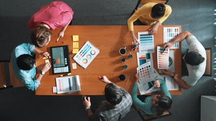 Wall Mural - Top view of business people working together to design web design. Aerial view of designer brainstorming and discussing about website interface and looking at tablet with digital design. Symposium.