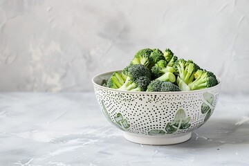 Wall Mural - Fresh green broccoli in a white bowl on a light background