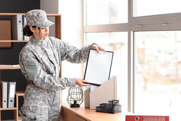 Wall Mural - Female African-American soldier with clipboard working at headquarters