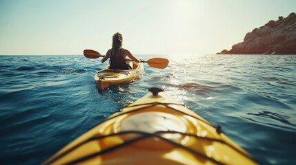 A kayaker exploring rocky valley in shallow sea