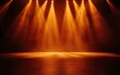 © Krungpol - Illuminated stage with warm orange lights creating a vibrant atmosphere ready for a performance or event.