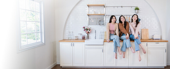 Closeup portrait of young beautiful asian group of friends girl sit on kitchen counter Beauty blogger woman with perfect glow skin Health care woman, together lifestyle cosmetic blogger banner