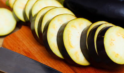 Wall Mural - Organic eggplant on wooden cutting board. Healthy nutrition concept