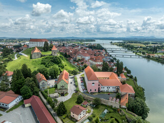 Wall Mural - Aerial view of Ptuj castle with red roof gothic renaissance palace building, bastions, towers on a hilltop above the old town, Drava river in Slovenia