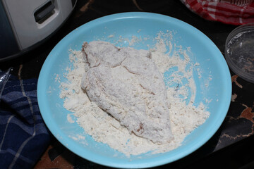 Chicken meat is coated in seasoned flour, Flouring Chicken Before Frying