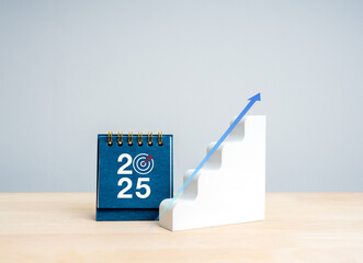Poster - happy new year 2025 background. 2025 numbers with target icon on blue small desk calendar near geome