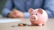 © 1000lnw - A cute pink piggy bank sits with coins, symbolizing savings and financial planning. Perfect for investment and budgeting themes.