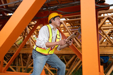 Wall Mural - Asia engineer man worker use tablet computer checking  spare crane 	